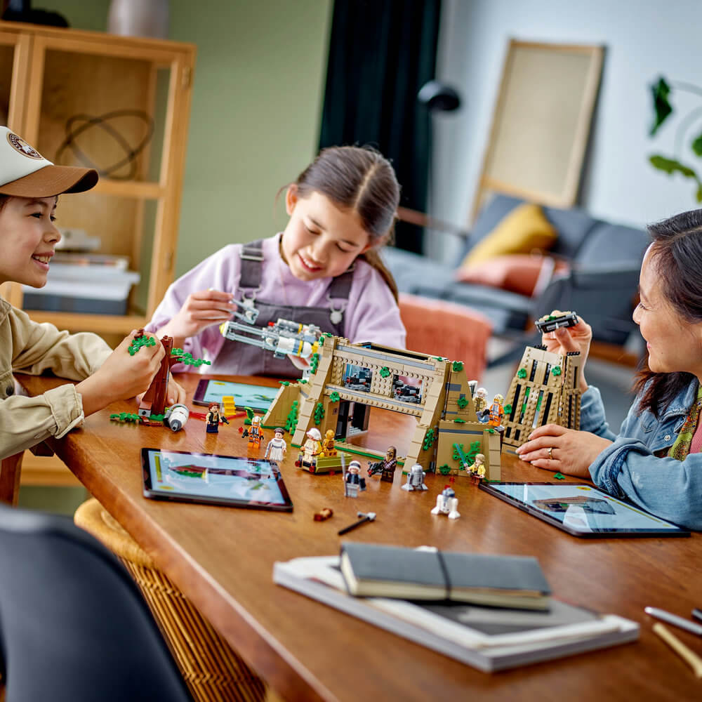 Three people shown playing with the LEGO® Star Wars™ Yavin 4 Rebel Base 75365 Building Toy Set (1,067 Pieces)