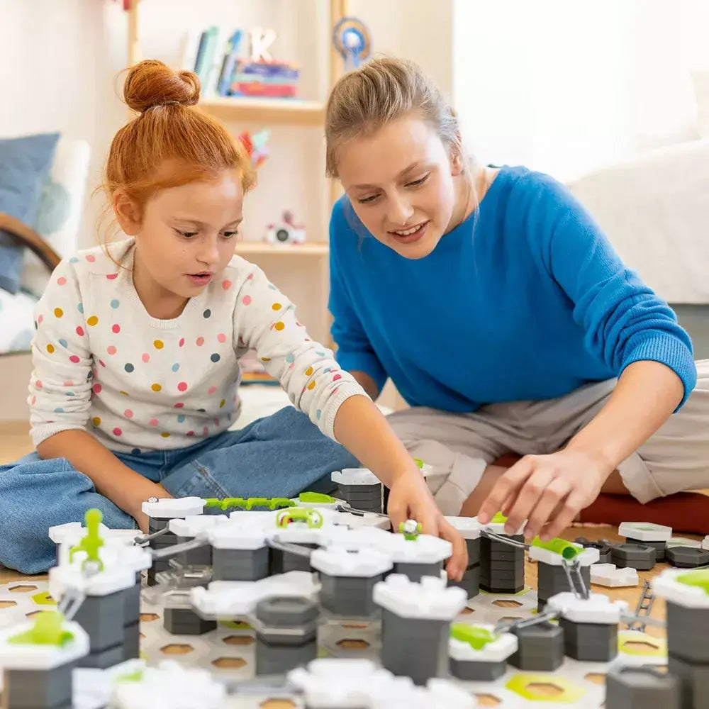 A mother and daughter working together to put together a GraviTrax Set.