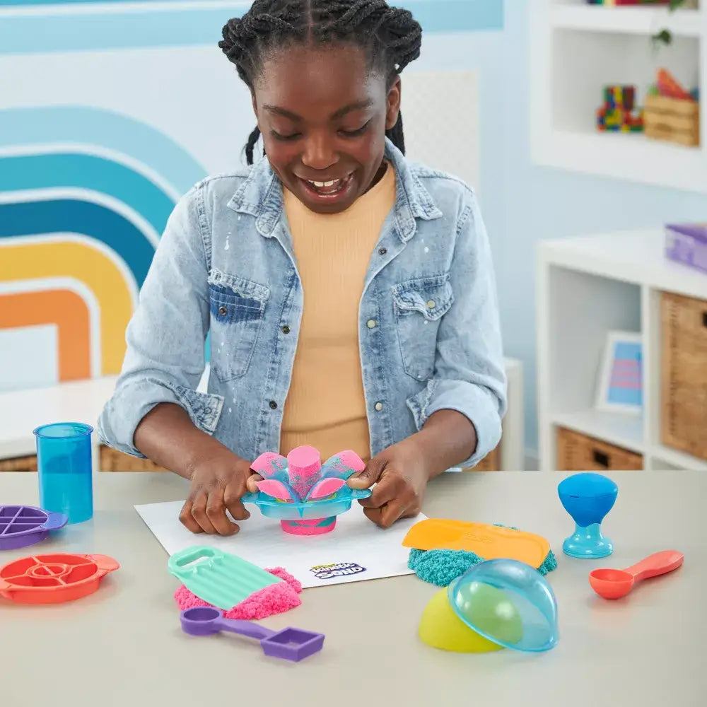 Girl playing with the Kinetic Sand Ultimate Satisfying Set