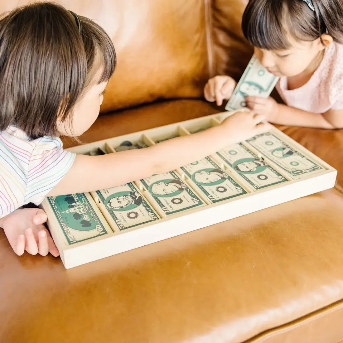 Kids playing with the Melissa and Doug Classic Play Money Set