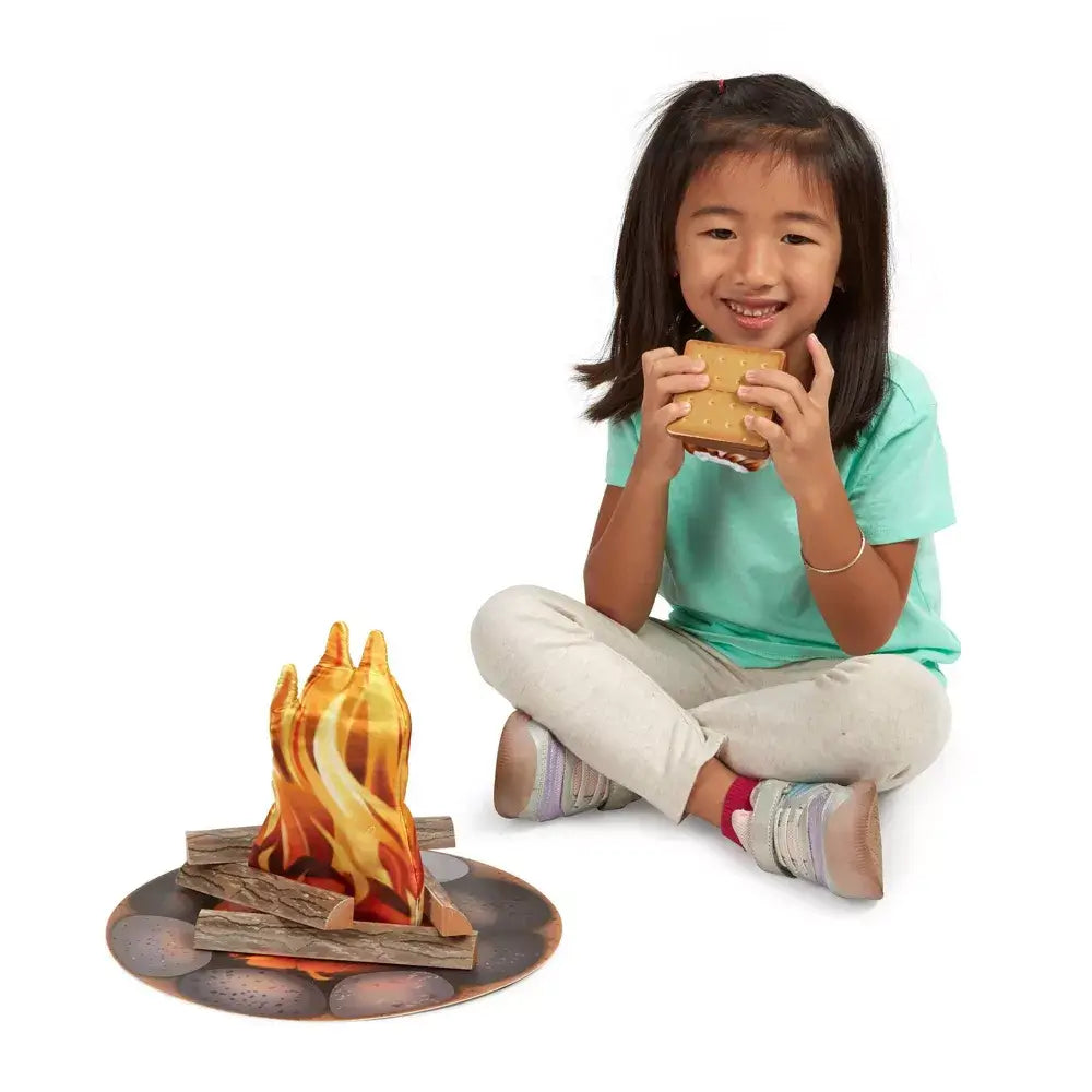 Girl wearing light green shirt holding sandwich and using campfire set