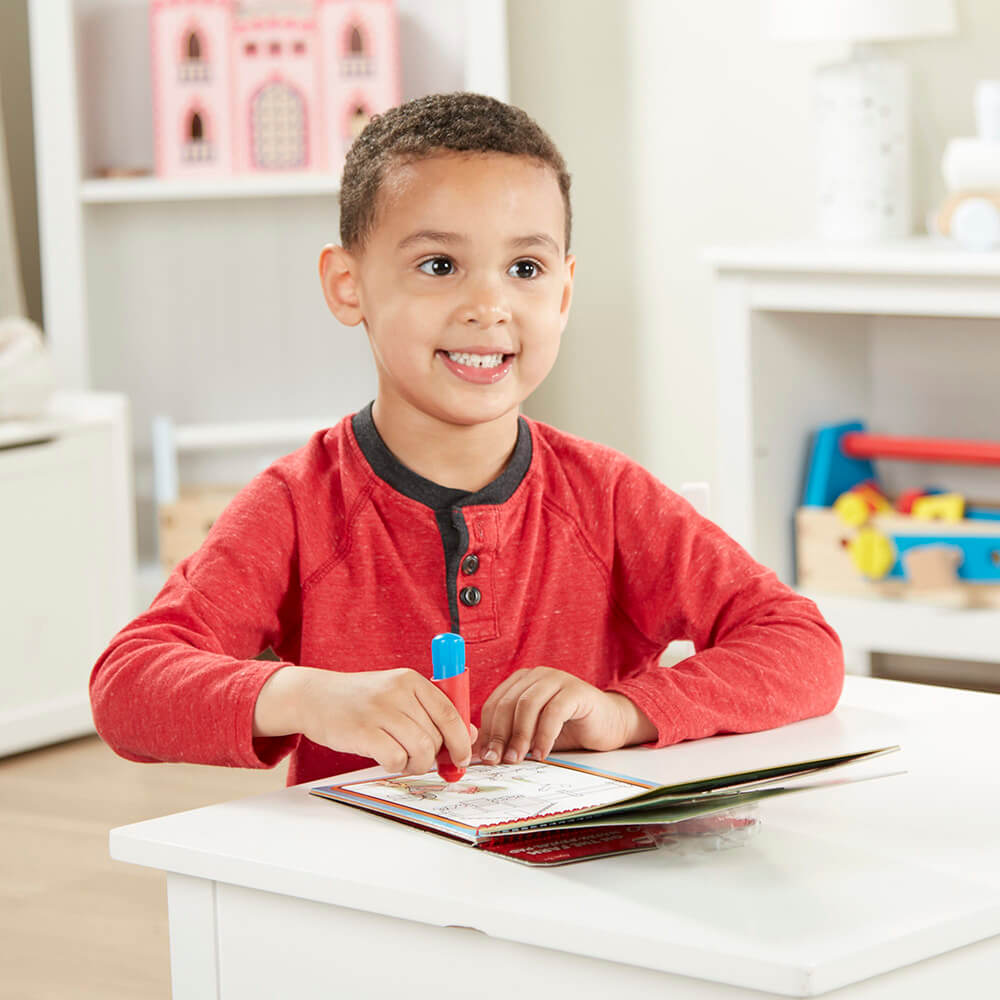 Boy coloring with water in his Melissa and Doug Water Wow! Farm Water-Reveal On the Go Travel Activity Pad