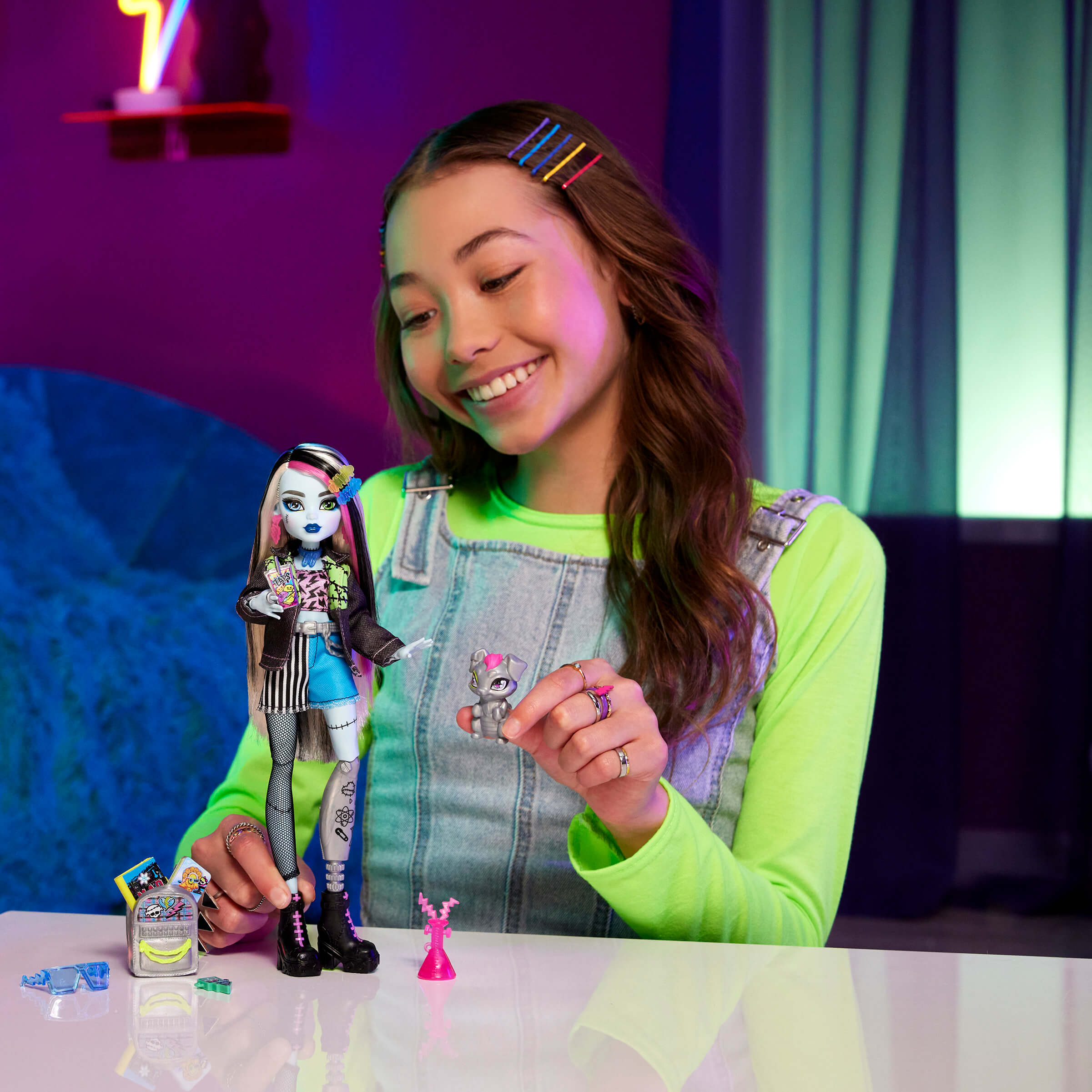 Girl playing with the Monster High Frankie Stein Doll and Pet