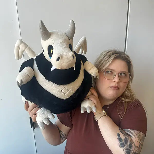 Woman holding the Squishable Bone Dragon Plush