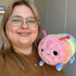 Woman holding the Squishable Mini Rainbow Caterpillar Plush