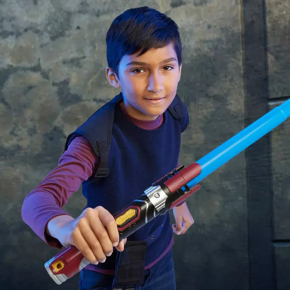 Boy posing with the Star Wars Lightsaber Forge Anakin Skywalker Extendable Blue Lightsaber