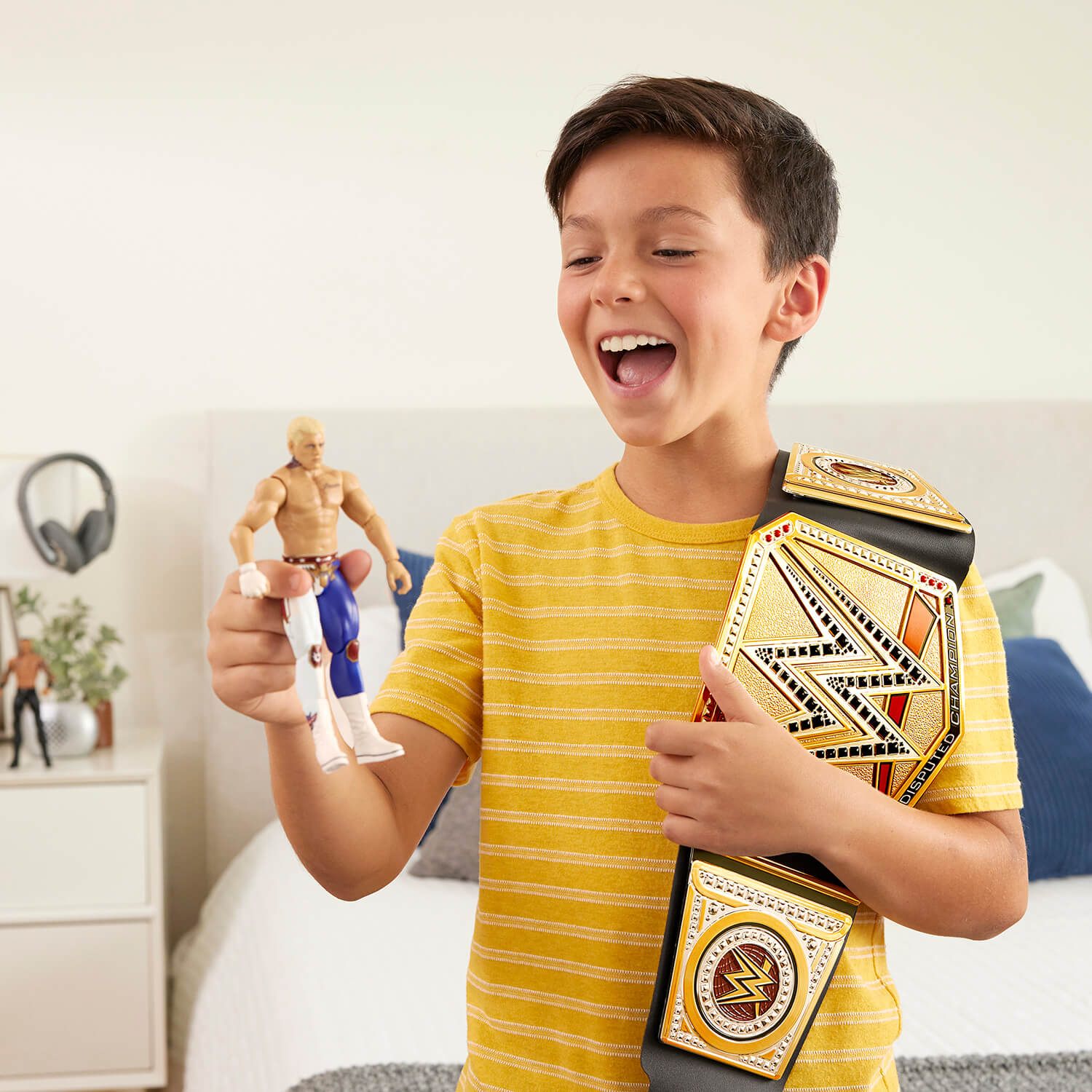 Boy playing with the WWE Undisputed WWE Universal Championship Belt and wrestling figure