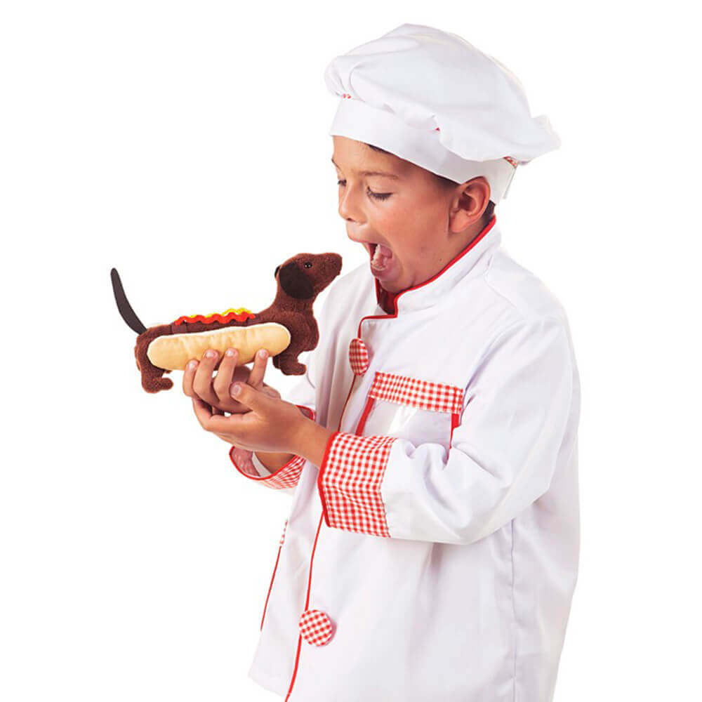 Boy dressed up as a chef is playing with this Dachshund finger puppet.